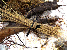 Load image into Gallery viewer, Ferro Rod - Ferro Rosd laying in a pile of tinder - Wilderness Survival Systems: Pocture