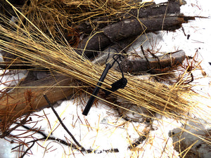 Ferro Rod - Ferro Rosd laying in a pile of tinder - Wilderness Survival Systems: Pocture