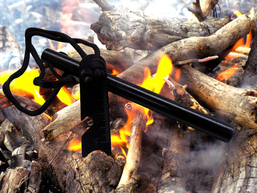 Ferro Rod - Ferro Rod and striker in fron of a fire - Wilderness Survival Systems : Picture